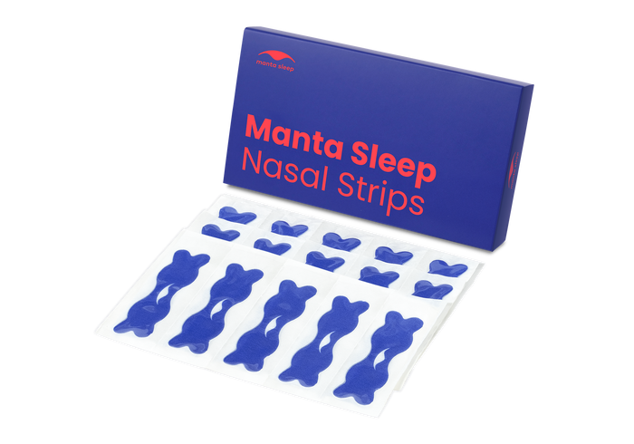 A blue Manta Sleep Nasal Strips product box standing next to several blue nasal strips in clear backing sheets, isolated on white.
