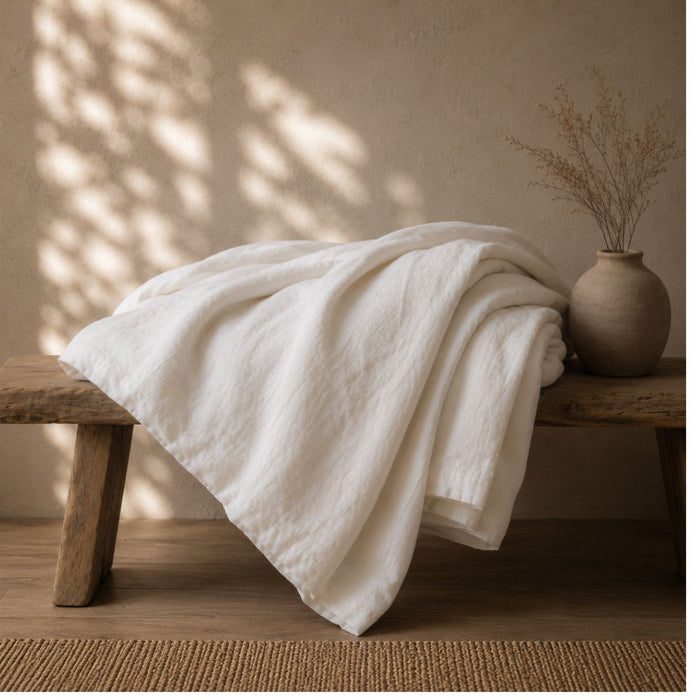 Pearl white linen cotton blend duvet cover draped on bench — BEDLAM